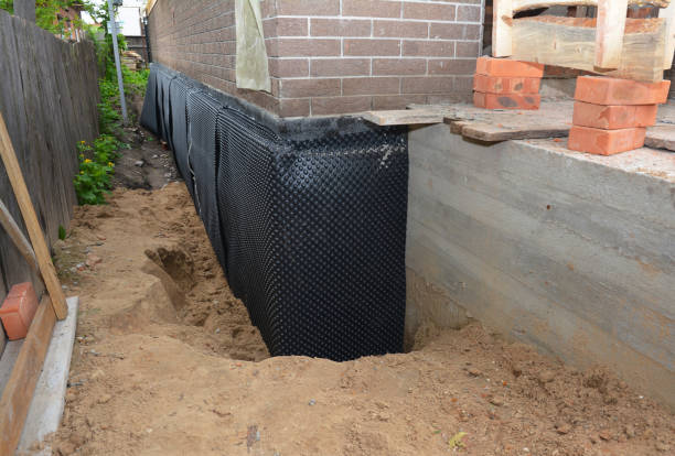 Happy homeowners after waterproofing job in Belding